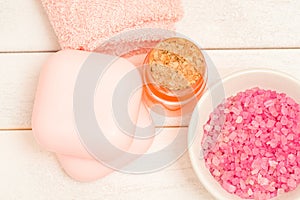 Pink spa salt in a bowl and soap