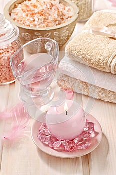 Pink spa set: liquid soap, scented candles, towels and rose sea