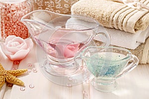 Pink spa set: liquid soap, scented candles, towels and rose sea