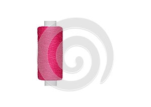 pink spool of sewing thread isolated on white background