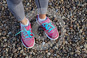 Pink sports shoes on gravel