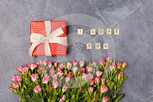 Pink spray roses, gift red box and I love you text on grey background. Woman`s Day Mother`s St. Valentine`s Day concept