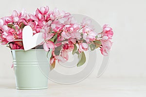 pink spring flowers in a bucket greeting card banner