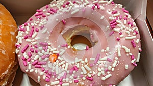 Pink sprinkles on donuts