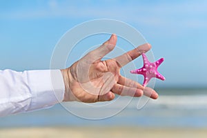Pink Star fish in hand business man