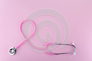 Pink stethoscope on pink background, Symbol of breast cancer in women, Health care concept