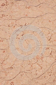 Pink stone with cracks and specks, called Perlino Rosato photo