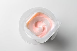 Pink strawberry yogurt cup on white