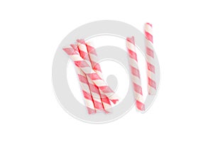 Pink striped wafer stick rolls on white background