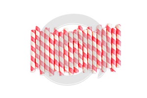 Pink striped wafer stick rolls on white background