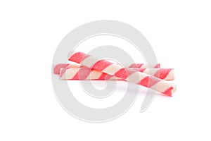 Pink striped wafer stick rolls on white background