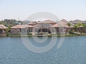 Pink Stucco Home with Pink Tile Roof Spans Lakefront