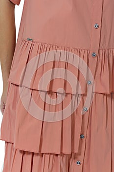 Pink summer dress fragment with ruches on model girl close up photo