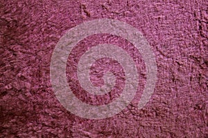 Pink surface of worn material.