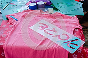 Pink T-shirt templates with letters Aleph Bet Gimel Dalet in Hebrew for drawing on a table
