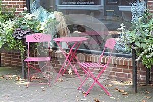 The pink table and chairs outside the cafe.