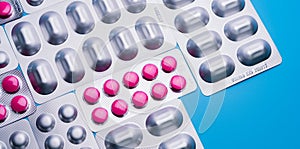 Pink tablets in blister pack and silver aluminium foil pack for capsule and tablets pills in pharmaceutical industry.