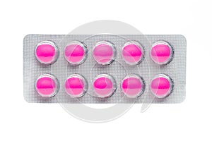 Pink tablets pills in blister pack isolated on white background.