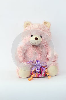 Pink teddy bear and gift boxes.