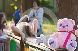 Pink teddy bear on the playground