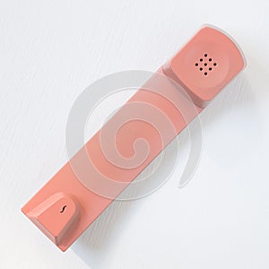 Pink telephone receiver isolated on white background