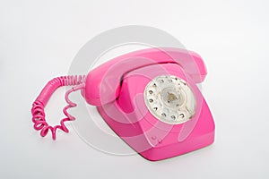 Pink telephone on a white background