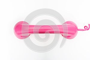 Pink telephone on a white background