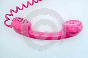 Pink telephone on a white background