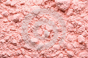 Pink texture of loose blush close up. Loose powdery make-up product. Broken compact powder close-up. Beauty cosmetic