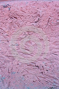 Pink texture of a stone wall from a mortar with recesses. photo