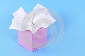 Pink tissue box, kleenex style, blue background, copy space