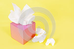 Pink kleenex style tissue box yellow background copy space