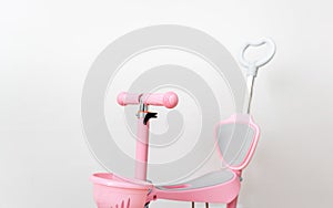 Pink toddler scooter for a baby. Summertime activity for kids.