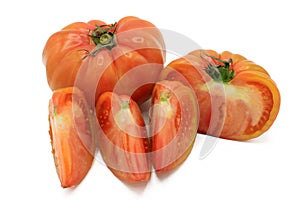 Pink tomato cut into chunks, isolated on a white background