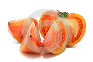 Pink tomato cut into chunks, isolated on a white background