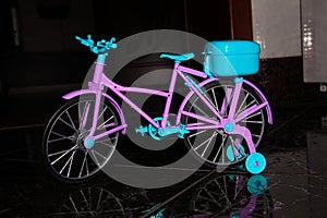 Pink toy bike. Pink and blue transport for dolls