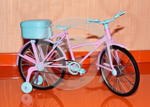 Pink toy bike. Pink and blue transport for dolls