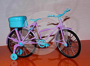 Pink toy bike. Pink and blue transport for dolls