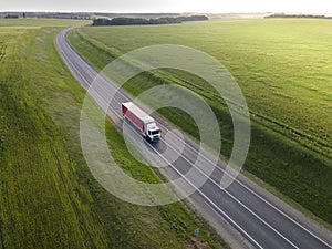 Pink Truck with Cargo Semi Trailer Moving on Road in Direction. Highway intersection junction. Aerial Top View