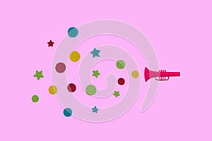 pink trumpet is advertised on a pink background, creative design, geometric shapes coming out of the trumpet