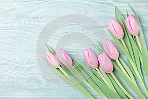 Pink tulip flowers on rustic table for March 8, International Womans or Mothers day. Beautiful spring card. Top view.