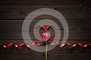 Pink tulip and ribbon shaped heart on wooden background. Valentines day, Mothers Day, Happy Birthday, Wedding, Womens Day -Concept