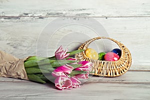 Pink tulips and basket with eggs