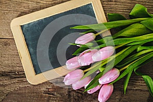 Pink tulips on the blackboard