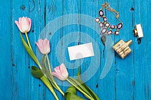 Pink tulips on a blue wooden board