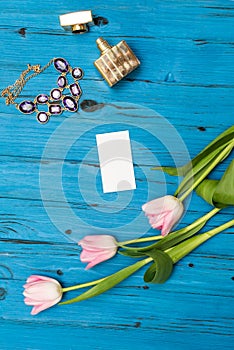 Pink tulips on a blue wooden board