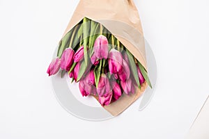 Pink tulips in a package of craft on the white background. Pink tulip. Tulips. Flowers. Flower background. Flowers photo