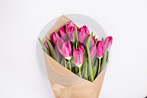 Pink tulips in a package of craft on the white background. Pink tulip. Tulips. Flowers. Flower background. Flowers photo