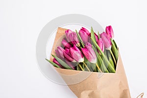 Pink tulips in a package of craft on the white background. Pink tulip. Tulips. Flowers. Flower background. Flowers photo