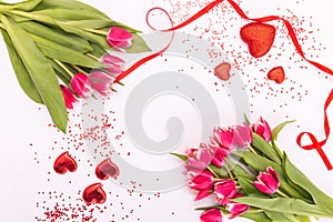 Pink tulips with ribbon and hearts isolated on white background Greeting card for Valentine`s Day, Women`s Day or Mother`s Day.